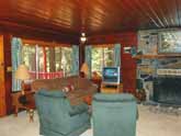 Yosemite rental cabin has a comfortable living room with a wood burning fireplace